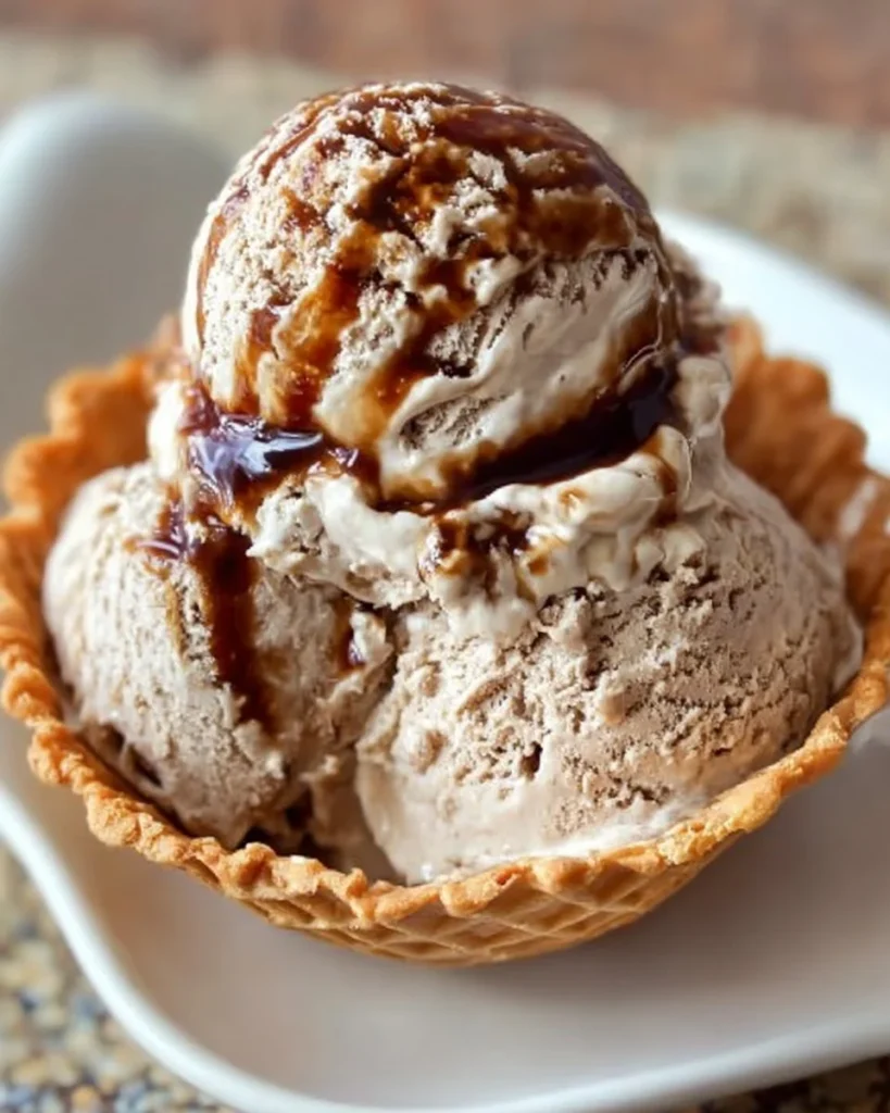 Delicious bowl of creamy root beer ice cream topped with foam.