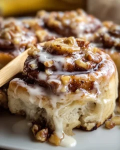 Freshly baked Banana Nut Cinnamon Rolls with nuts and cinnamon on a plate