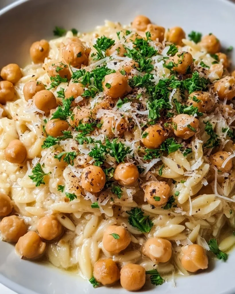 Creamy lemon ricotta orzo with chickpeas served in a bowl.