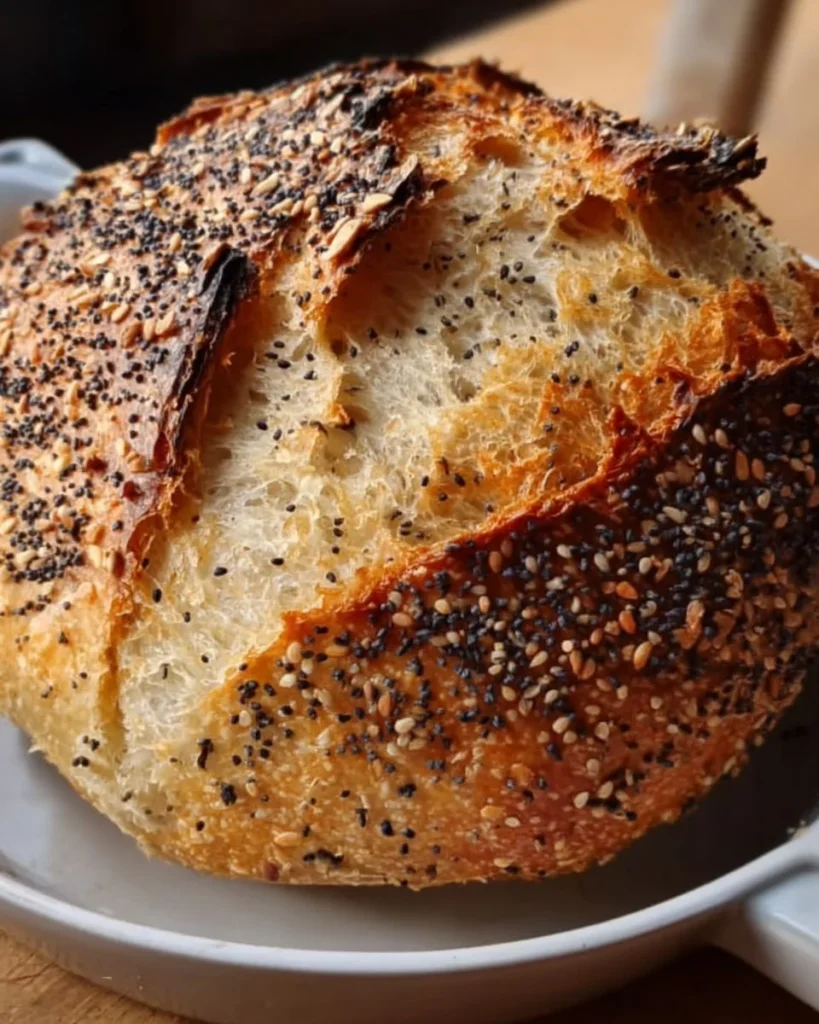 Same-Day Sourdough Boule with Everything Seeds freshly baked on a wooden table