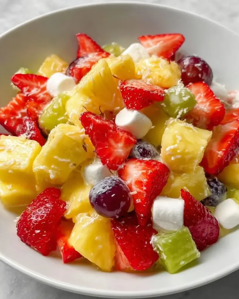 Pina Colada Fruit Salad featuring fresh tropical fruits and coconut.