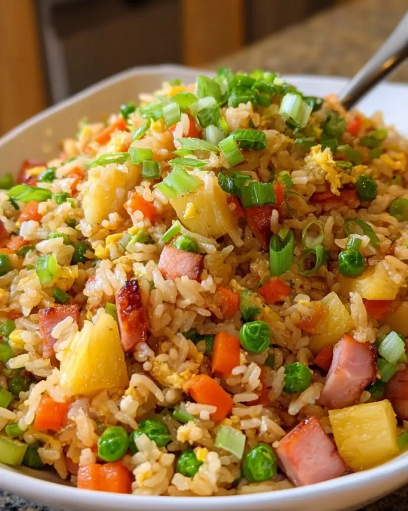Delicious Pineapple Fried Rice with Ham served in a bowl with fresh ingredients