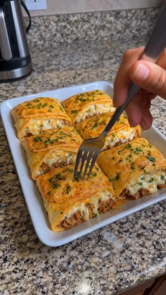 Homemade cheeseburger pockets filled with beef and cheese on a plate.