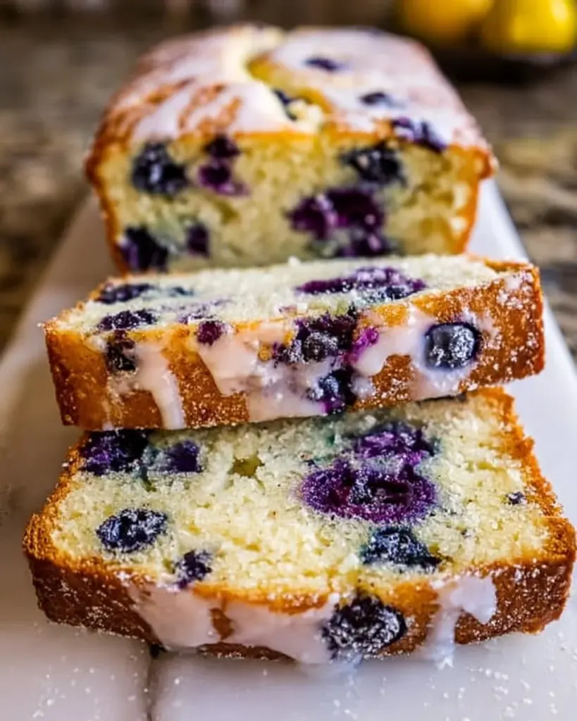 Slice of Lemon Blueberry Bread with fresh blueberries and lemon zest