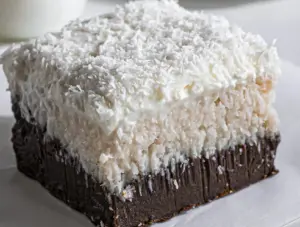 Delicious Coconut Cream Brownies with creamy coconut frosting on top.