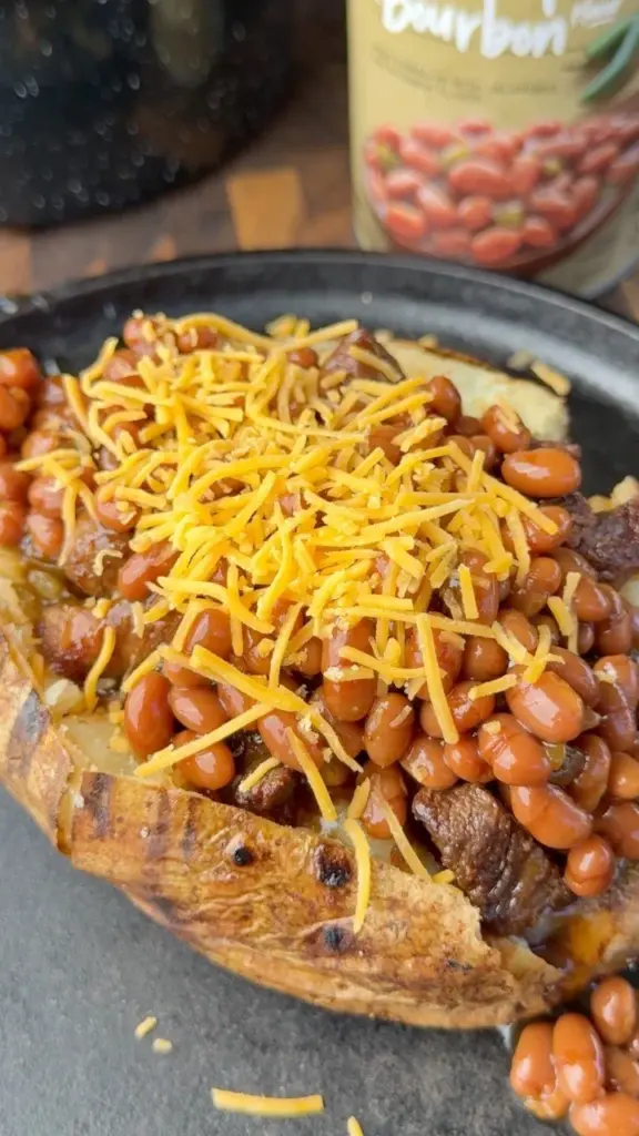 Perfectly made loaded baked potatoes topped with cheese, bacon, and chives.