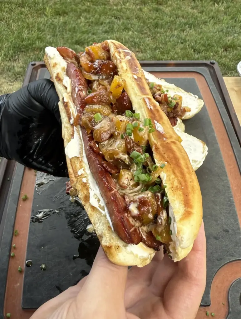 Delicious gourmet hotdogs served with toppings on a wooden platter