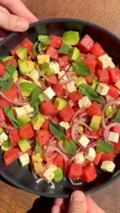 Watermelon salad with feta cheese and avocado on a plate